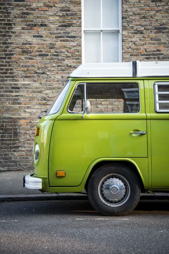 Trendy vintage bright green campervan with white roof
