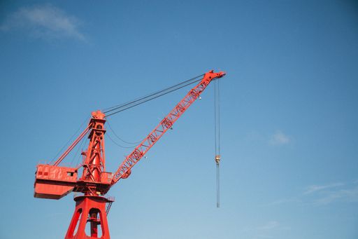 A red crane against a blue sky