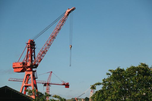 A red crane against a blue sky