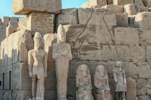 Stone sculptures in famous Karnak Temple Complex (Luxor, Egypt). Daylight and blue sky