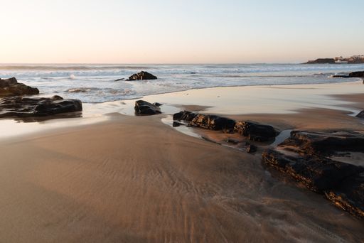A beautiful view of a beach with rocks at sunset in the Canary Islands, Spain