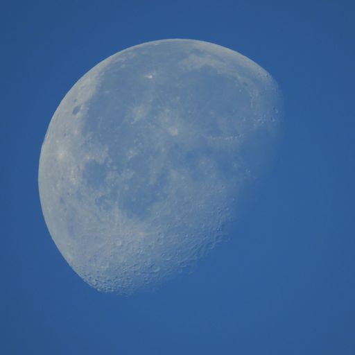 A beautiful view of a moon in a blue sky - perfect for background