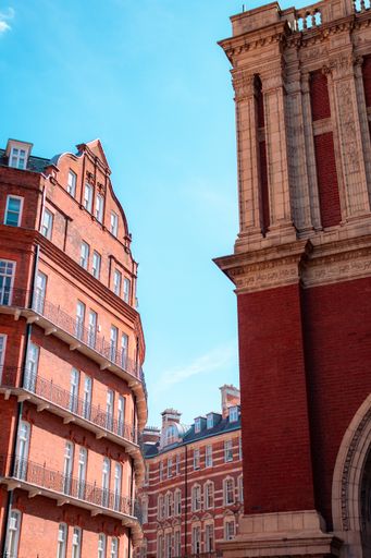 A vertical closeup low-angle shot of parts of red buildings