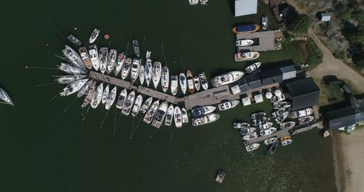 Aerial drone shot above a harbor full of sailboats, on Hogsara Island, in the archipelago, sunny, summer day, in Saaristomeri Varsinais-suomi, Finland