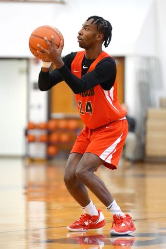 A vertical shot of young male players on the court at a fall Merrillville high school basketball game
