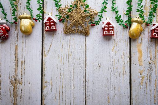 A shot of traditional Christmas decorations hanging on a wooden fence