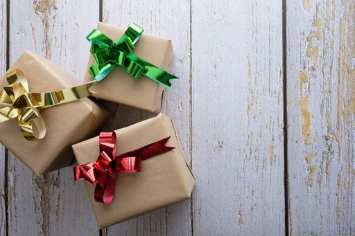 A shot of boxes with gifts on a wooden fence background