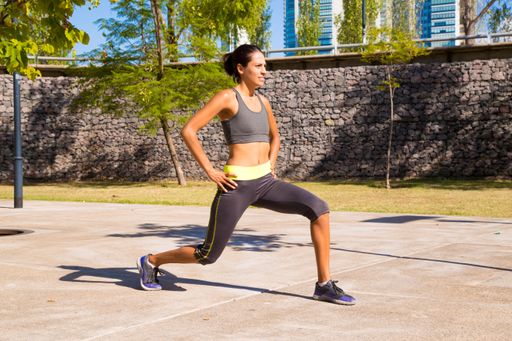 A beautiful shot of a young athletic female doing workout exercises on a sunny day
