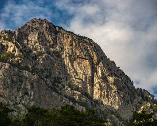 A beautiful view of rocky crag against a blue cloudy sky in Green Canyon
