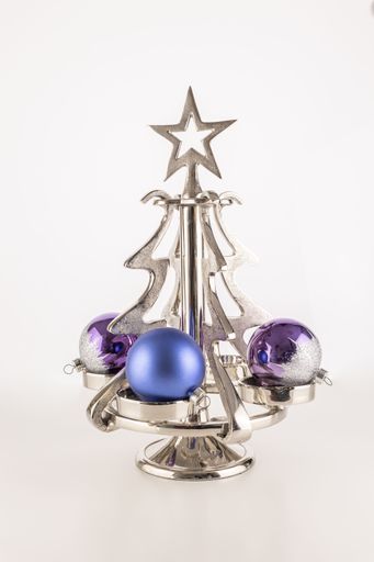 A vertical shot of ornaments on a small metallic Christmas tree isolated on a white background