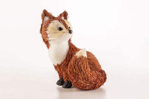 A closeup of a small cute fox toy isolated on a white background