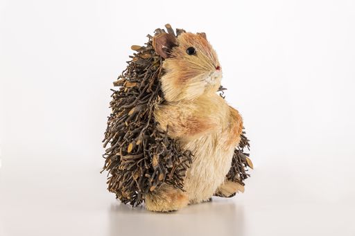 A closeup of a small cute hedgehog toy isolated on a white background