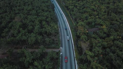 An aerial shot of a road surrounded by trees in Uvita, Costa Rica
