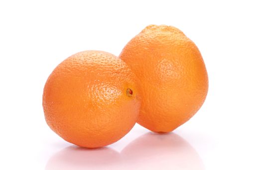 A closeup shot of two oranges isolated on a white background