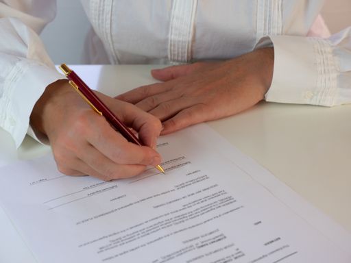 A business woman signing an official document or contract