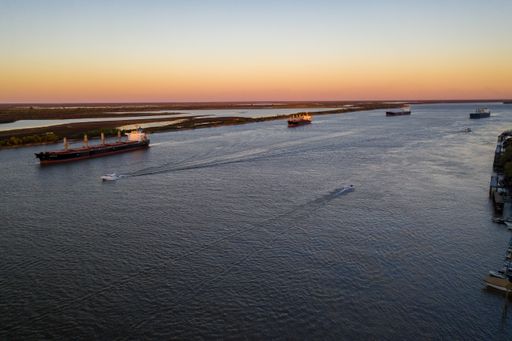 image without recognizable marks or people

Aerial shot over parang River in Front of Rosario City 
four ships waiting to be loaded with grain