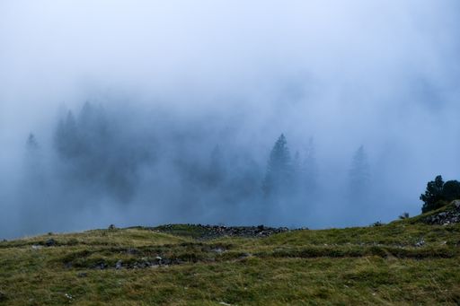 A mesmerizing view of beautiful mountains under a foggy and cloudy sky