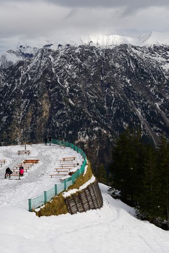 A vertical shot of a restaurant terrace in the Alps