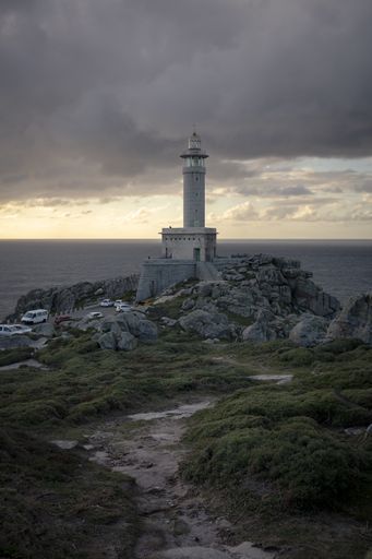 A vertical shot of the Punta Nariga Lighthouse in Galicia, Spain on a cloudy day