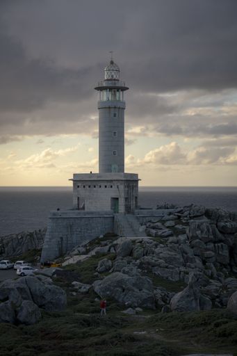 A vertical shot of the Punta Nariga Lighthouse in Galicia, Spain on a cloudy day