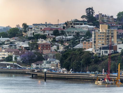 A buildings and the houses by the Brisbane River near the Port of Brisbane in Australia