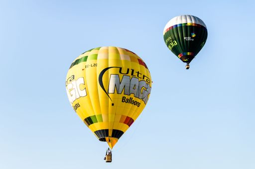A low-angle shot of hot air balloons flying in the air during the 25th European Balloon Festival