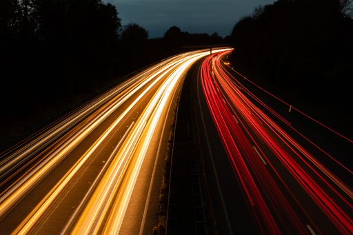 A beautiful and colorful long exposure of the driving cars on the highway at night