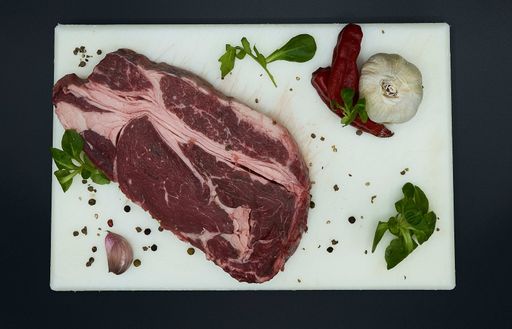An overhead shot of fresh raw beef steak with spices
