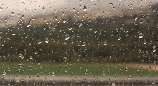 A closeup shot of a car window covered with raindrops