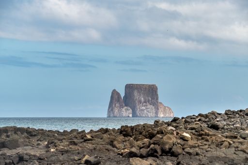 Kicker Rock island seen from San Cristobal island beach. Some clouds can be seen on the sky. Galapagos Islands, Ecuador