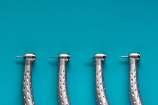 The flat lay of dental high-speed handpieces on the blue background