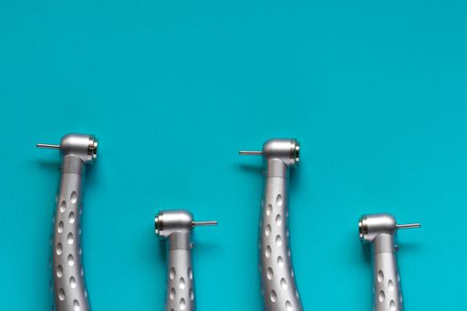 The flat lay of dental high-speed handpieces on the blue background
