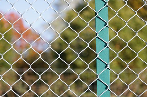 A selective focus shot of mesh fence