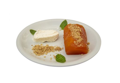 A closeup of a pumpkin dessert served on a white plate isolated on a white background