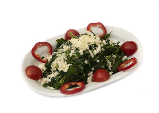 A top view closeup of a salad served on a white plate isolated on a white background
