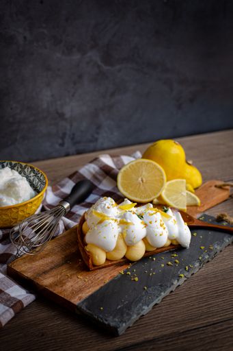 A vertical closeup of a delicious dessert served with sliced lemon