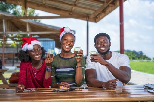 A group of friends enjoying a cup of coffee while celebrating Christmas
