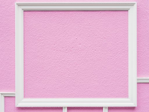 A closeup shot of a frame on a pink wall