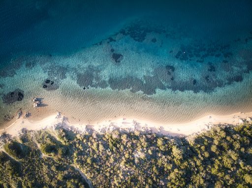 Aerial drone top view of sandy  beach and blue sea, Sardinia Italy