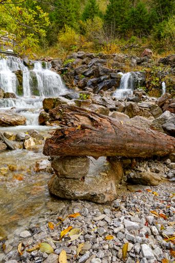 A beautiful view of waterfall water flowing through the rocks covered with moss in the Allgaeu Alps
