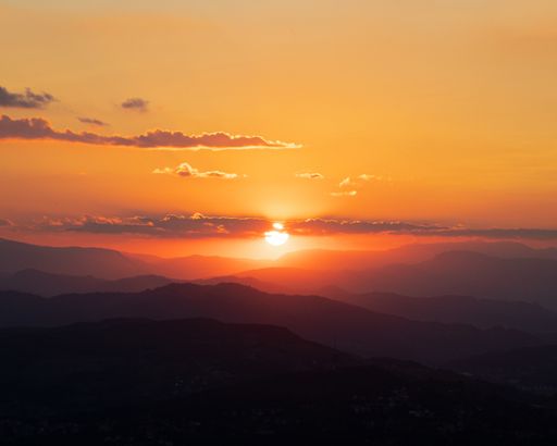 A beautiful scenery of a mountain range with the breathtaking sunset in the background