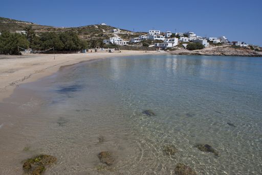 Beautiful sandy beach, Greece, Donoussa island. Crystal clear blue sea waters lap the pale sand. A quiet and peaceful seaside scene.