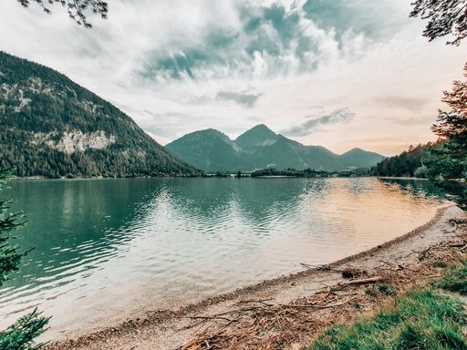 The cloudy sky over Heiterwanger See with its surrounding mountains