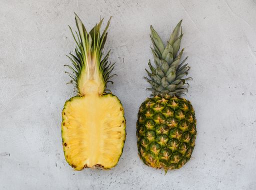 A flat lay of sliced pineapple against a white background