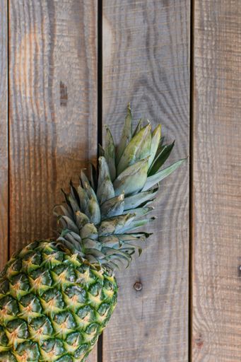 A flat lay of pineapple on a wooden table