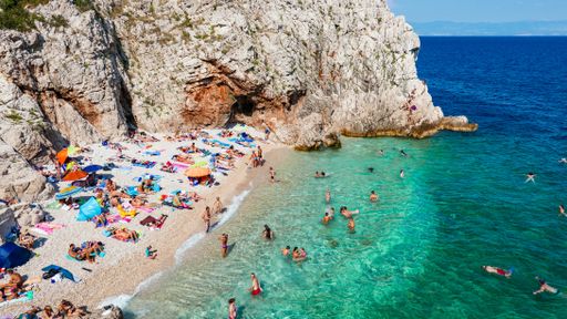 A breathtaking shot of Brsec beach on the eastern coast of Istria, Croatia. People on beach, summer vacation, travel.
