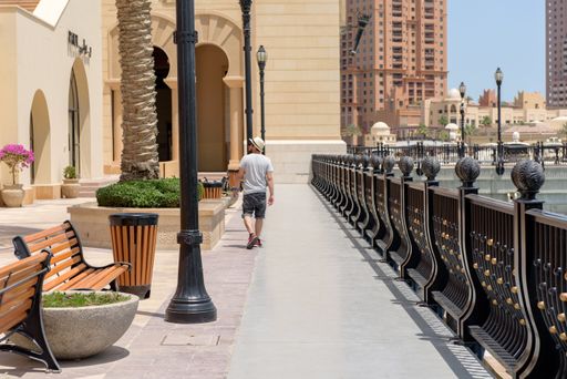 Doha, Qatar : May 8 2018 :  Young Men walk for Marina Bay , Doha, Qatar