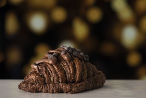 A closeup shot of a delicious croissant on blurred background