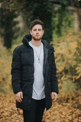 A shallow focus shot of a young and attractive male posing at camera