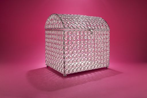 A chest with stones on a pink background